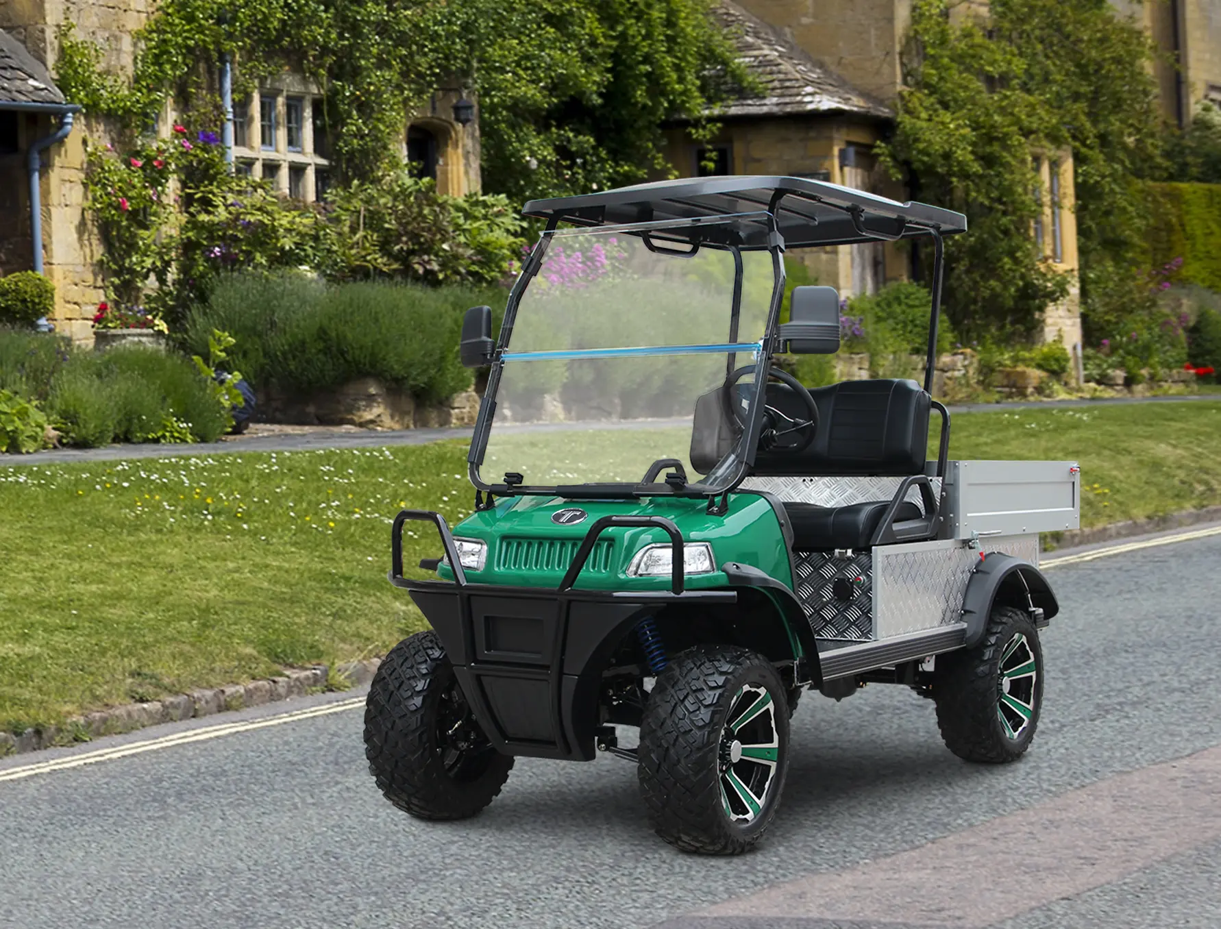 Green utility golf cart with aluminum flatbed driving on resort estate road lined with landscaped gardens — resort grounds maintenance configuration